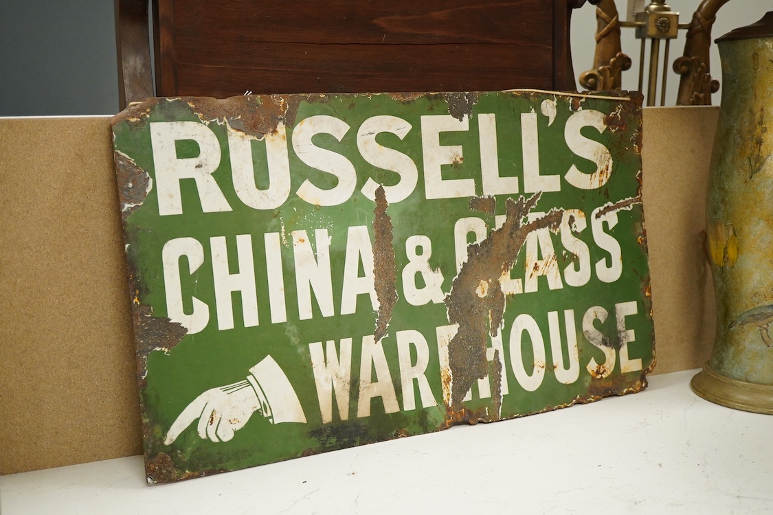 A Russell’s China & Glass Warehouse enamel advertising sign, 35.5 x 61cm